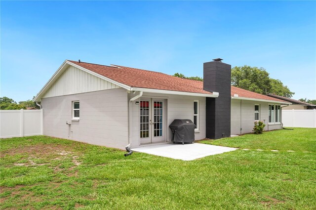 3080 Cross Fox Dr, Mulberry, FL 33860 - rear view of house featuring a chimney, french doors, a patio area, and roof with shingles
