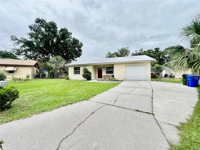 355 Pico Ct, Lakeland, FL 33809 - single story home featuring a garage, concrete driveway, a front yard, and metal roof