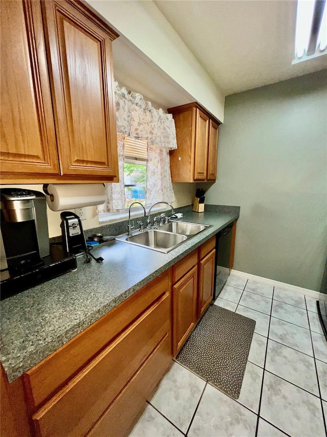 355 Pico Ct, Lakeland, FL 33809 - kitchen featuring a sink, brown cabinetry, black dishwasher, baseboards, and light tile patterned floors