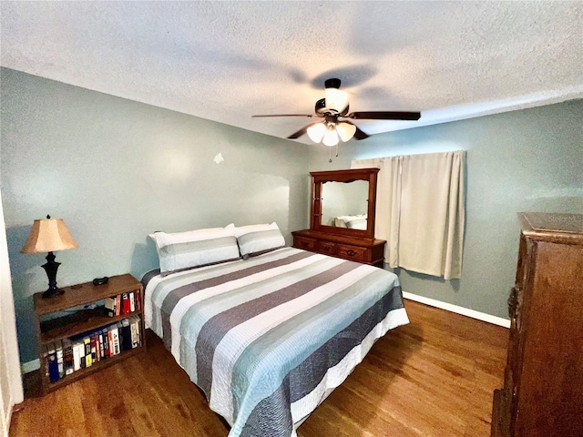 355 Pico Ct, Lakeland, FL 33809 - bedroom featuring a textured ceiling, wood finished floors, baseboards, and a ceiling fan