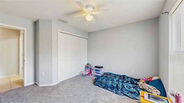 7337 Hunters Greene Cir, Lakeland, FL 33810 - unfurnished bedroom featuring carpet flooring, a ceiling fan, tile patterned floors, a closet, and baseboards