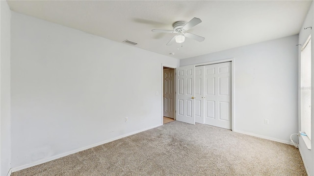 7337 Hunters Greene Cir, Lakeland, FL 33810 - unfurnished bedroom with carpet, baseboards, a closet, and a ceiling fan