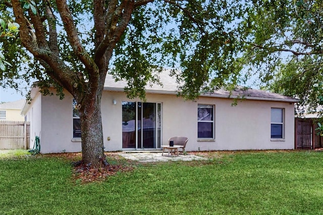 7337 Hunters Greene Cir, Lakeland, FL 33810 - back of house featuring stucco siding and a patio