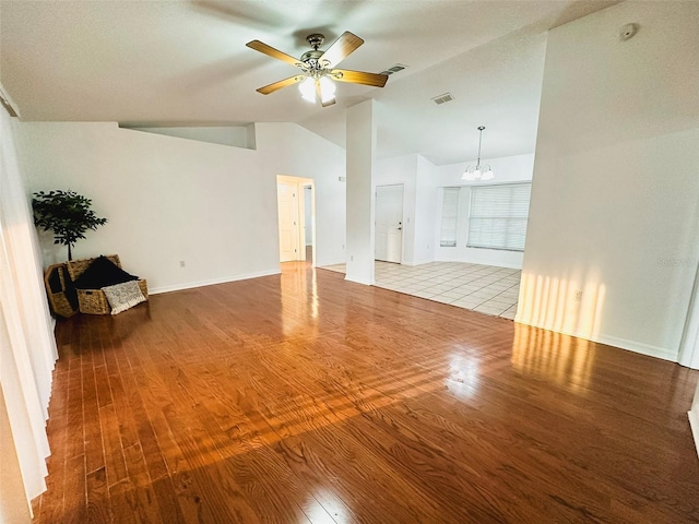 709 N Polk Ave, Fort Meade, FL 33841 - unfurnished living room featuring vaulted ceiling, wood finished floors, a ceiling fan, and baseboards