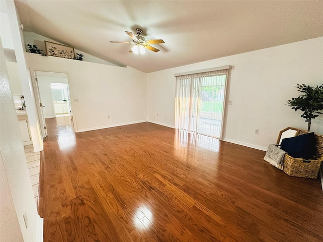 709 N Polk Ave, Fort Meade, FL 33841 - unfurnished living room featuring ceiling fan, lofted ceiling, wood finished floors, and baseboards