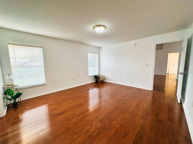 709 N Polk Ave, Fort Meade, FL 33841 - empty room featuring wood finished floors, a textured ceiling, and baseboards