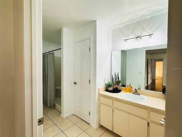 709 N Polk Ave, Fort Meade, FL 33841 - bathroom featuring tile patterned flooring, vanity, and a textured ceiling