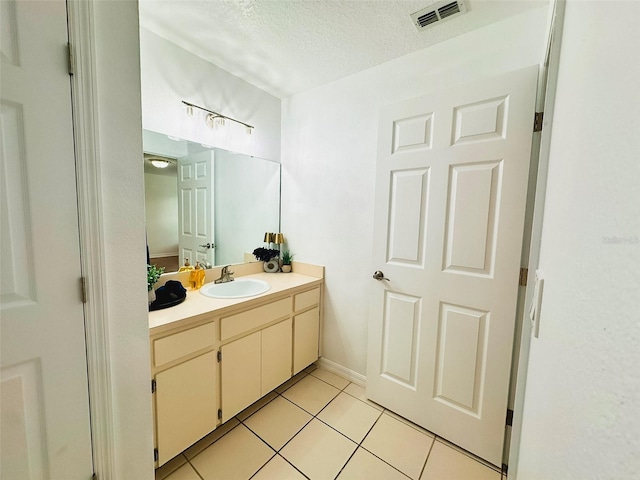 709 N Polk Ave, Fort Meade, FL 33841 - bathroom with vanity, a textured ceiling, and tile patterned floors
