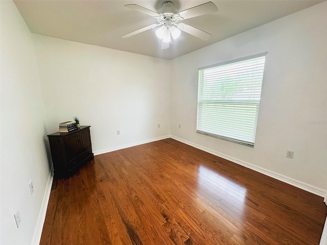 709 N Polk Ave, Fort Meade, FL 33841 - spare room with dark wood-style flooring, a ceiling fan, and baseboards