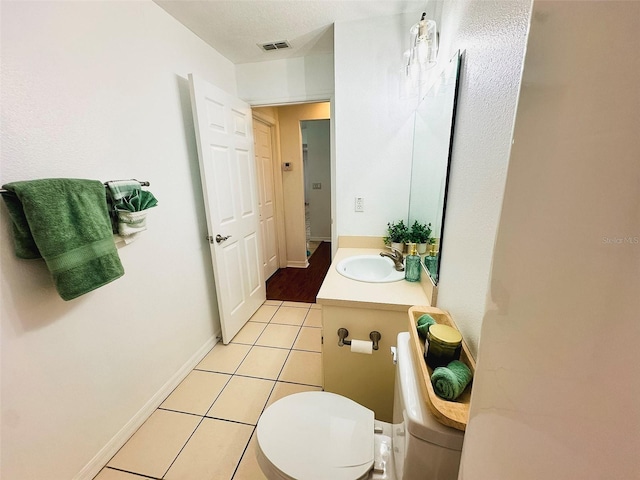 709 N Polk Ave, Fort Meade, FL 33841 - bathroom with vanity, toilet, tile patterned floors, and baseboards