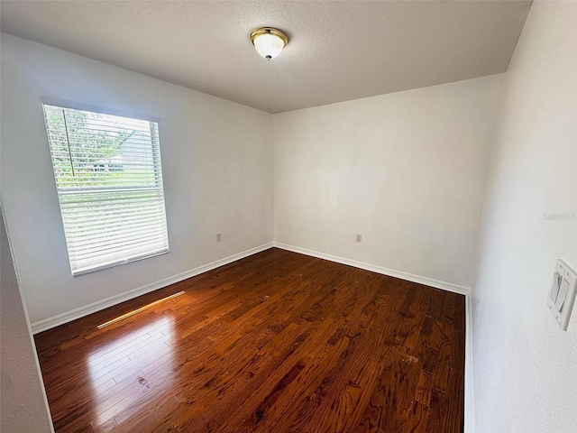 709 N Polk Ave, Fort Meade, FL 33841 - empty room with dark wood-style floors and baseboards