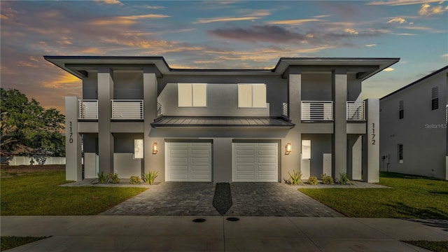1170 Windjammer Dr, Lakeland, FL 33803 - view of front of house featuring a balcony, decorative driveway, stucco siding, and a standing seam roof