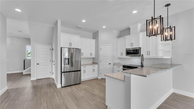 1170 Windjammer Dr, Lakeland, FL 33803 - kitchen featuring appliances with stainless steel finishes, open shelves, light stone countertops, backsplash, and white cabinetry