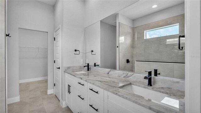 1170 Windjammer Dr, Lakeland, FL 33803 - bathroom with double vanity, a tile shower, a walk in closet, and recessed lighting