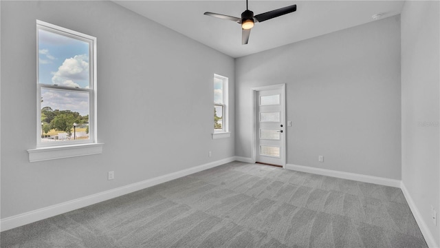 1170 Windjammer Dr, Lakeland, FL 33803 - empty room featuring light carpet, ceiling fan, and a smoke detector