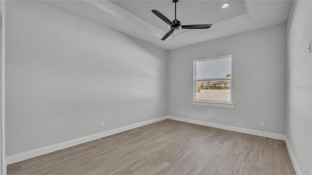 1170 Windjammer Dr, Lakeland, FL 33803 - spare room with a tray ceiling, light wood-style flooring, ceiling fan, and recessed lighting