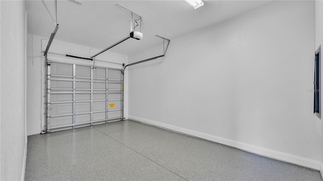 1170 Windjammer Dr, Lakeland, FL 33803 - garage featuring a garage door opener and baseboards
