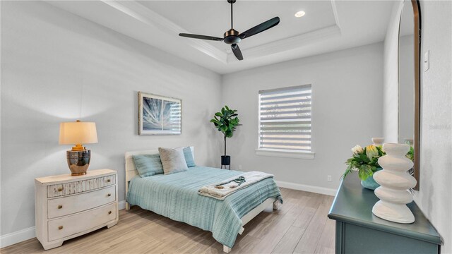 1170 Windjammer Dr, Lakeland, FL 33803 - bedroom featuring a raised ceiling, light wood-style flooring, recessed lighting, and ceiling fan