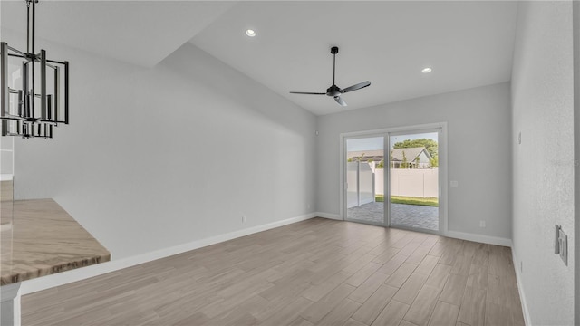 1172 Windjammer Dr, Lakeland, FL 33803 - unfurnished living room featuring ceiling fan, wood finished floors, recessed lighting, and lofted ceiling