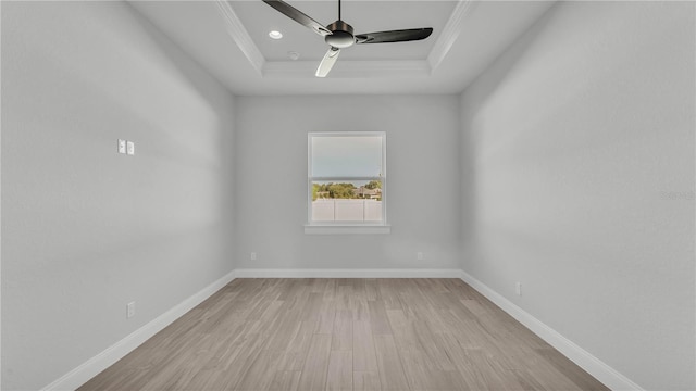 1172 Windjammer Dr, Lakeland, FL 33803 - empty room with a tray ceiling, light wood-style flooring, a ceiling fan, and crown molding