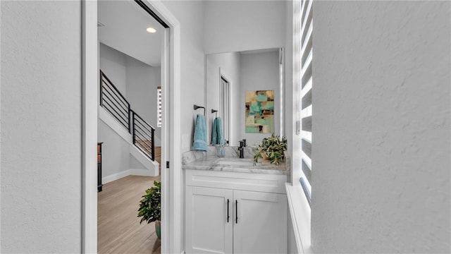 1172 Windjammer Dr, Lakeland, FL 33803 - hall with a textured wall, stairs, and light wood-style floors