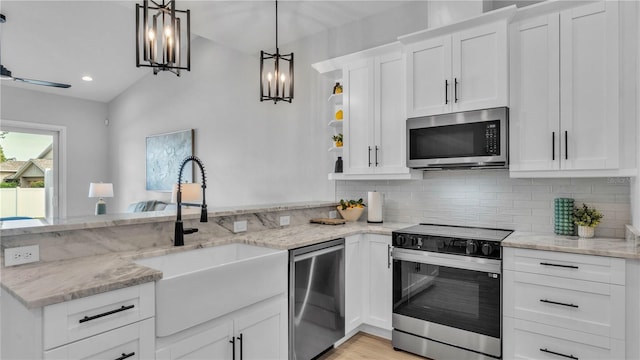1172 Windjammer Dr, Lakeland, FL 33803 - kitchen with stainless steel appliances, a peninsula, backsplash, white cabinets, and recessed lighting