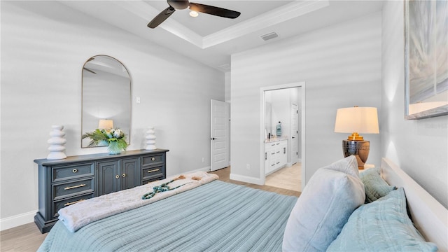 1172 Windjammer Dr, Lakeland, FL 33803 - bedroom with a raised ceiling, light wood-style flooring, ornamental molding, ensuite bath, and a ceiling fan