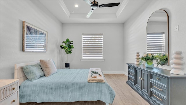 1172 Windjammer Dr, Lakeland, FL 33803 - bedroom featuring a tray ceiling, light wood-style floors, crown molding, ceiling fan, and recessed lighting
