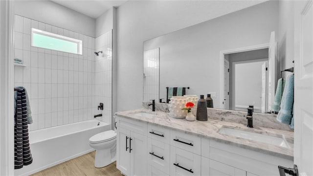 1172 Windjammer Dr, Lakeland, FL 33803 - bathroom featuring double vanity, shower / bath combination, and wood finished floors