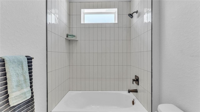 1172 Windjammer Dr, Lakeland, FL 33803 - full bathroom with a textured wall and  shower combination