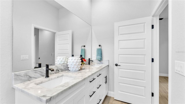 1172 Windjammer Dr, Lakeland, FL 33803 - full bathroom with double vanity and wood finished floors