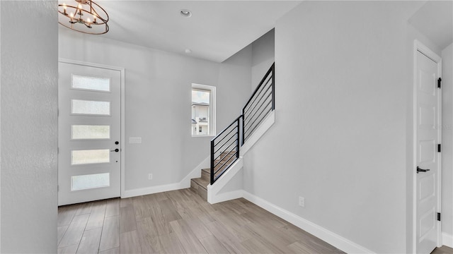 1172 Windjammer Dr, Lakeland, FL 33803 - foyer entrance with stairs, a chandelier, and wood finished floors