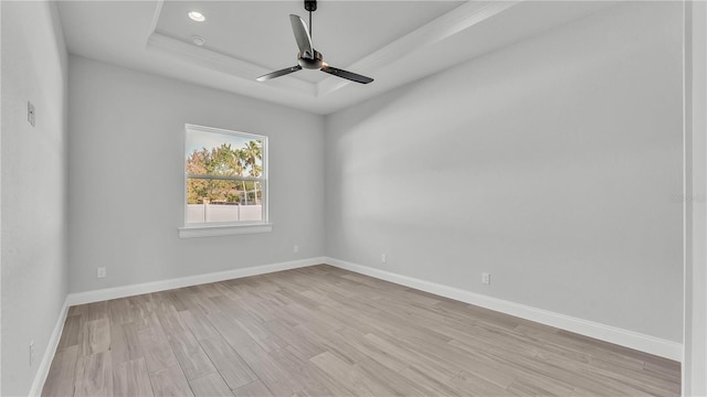 1172 Windjammer Dr, Lakeland, FL 33803 - empty room with a tray ceiling, light wood-type flooring, and a ceiling fan