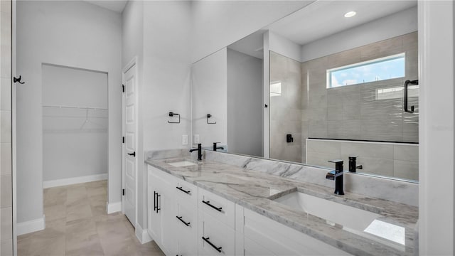 1172 Windjammer Dr, Lakeland, FL 33803 - bathroom with double vanity, a tile shower, a walk in closet, and recessed lighting