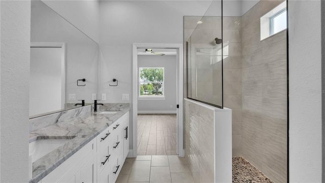 1172 Windjammer Dr, Lakeland, FL 33803 - full bath featuring a walk in shower, double vanity, ceiling fan, and tile patterned flooring