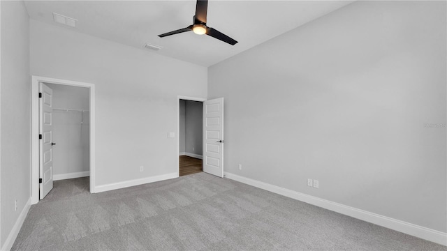 1172 Windjammer Dr, Lakeland, FL 33803 - unfurnished bedroom with carpet flooring, a walk in closet, lofted ceiling, a closet, and a ceiling fan