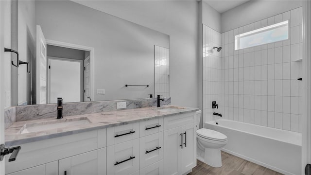 1172 Windjammer Dr, Lakeland, FL 33803 - full bath with double vanity, wood finished floors, and shower / bathtub combination
