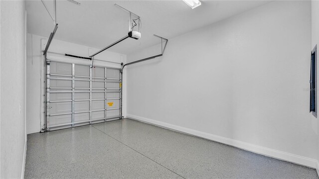 1172 Windjammer Dr, Lakeland, FL 33803 - garage featuring a garage door opener and baseboards