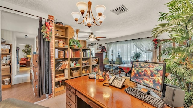 841 E Valencia St, Lakeland, FL 33805 - office area with a chandelier, ceiling fan, light wood-style flooring, and a textured ceiling