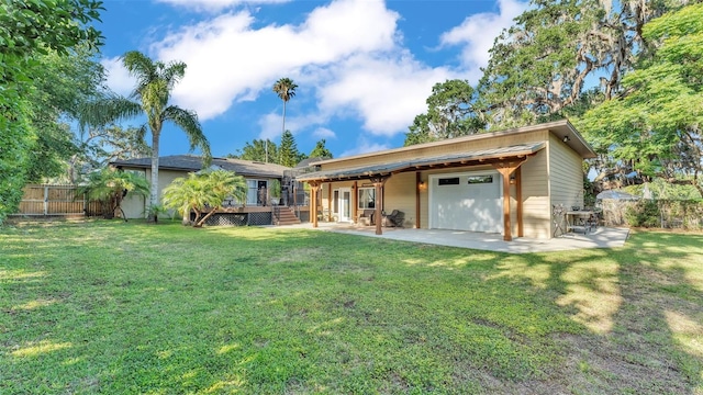 841 E Valencia St, Lakeland, FL 33805 - rear view of property featuring a deck, a patio area, and a garage
