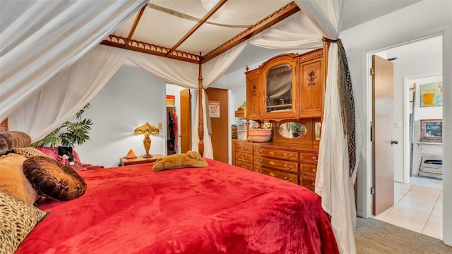 841 E Valencia St, Lakeland, FL 33805 - bedroom featuring light tile patterned floors, a walk in closet, and light carpet