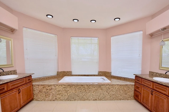 943 Hamilton Place Ln, Lakeland, FL 33813 - bathroom with a wall mounted AC, a garden tub, two vanities, and tile patterned flooring