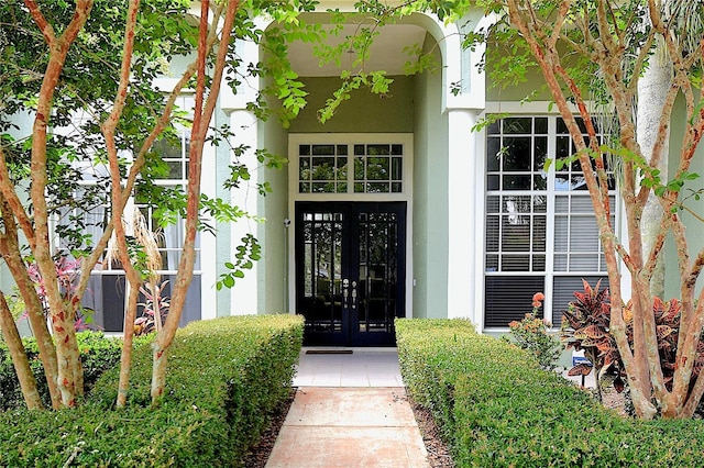943 Hamilton Place Ln, Lakeland, FL 33813 - property entrance featuring french doors and stucco siding