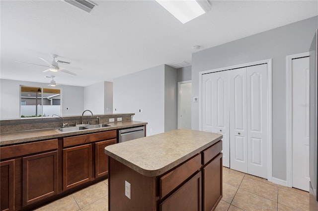 6819 Glenbrook Dr, Lakeland, FL 33811 - kitchen featuring a sink, light tile patterned floors, stainless steel dishwasher, a center island, and a ceiling fan