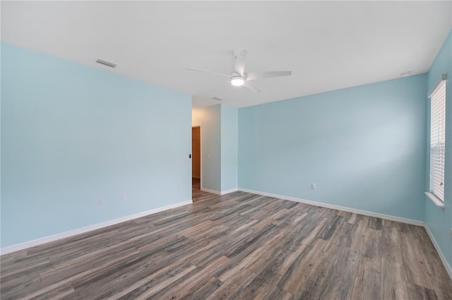 6819 Glenbrook Dr, Lakeland, FL 33811 - spare room with wood finished floors, a ceiling fan, and baseboards