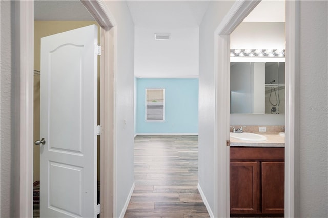 6819 Glenbrook Dr, Lakeland, FL 33811 - hallway with a sink, wood finished floors, and baseboards