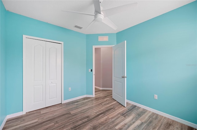 6819 Glenbrook Dr, Lakeland, FL 33811 - unfurnished bedroom featuring wood finished floors, baseboards, a closet, and ceiling fan