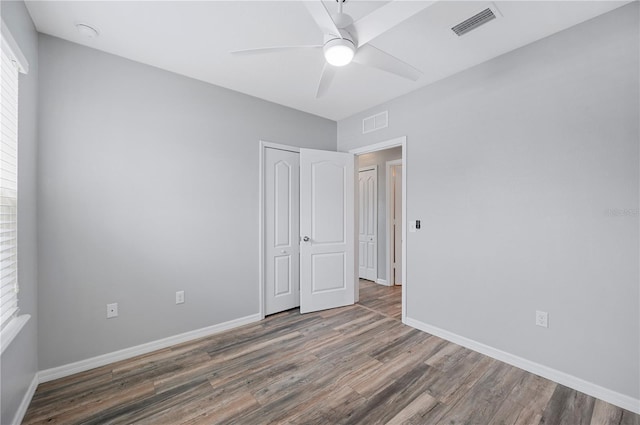 6819 Glenbrook Dr, Lakeland, FL 33811 - unfurnished bedroom with wood finished floors, baseboards, a closet, and a ceiling fan
