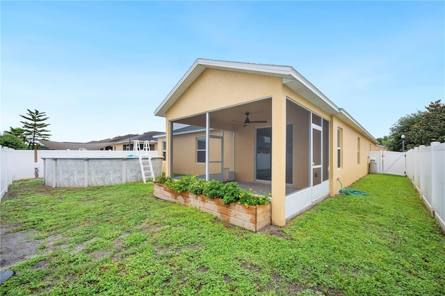 6819 Glenbrook Dr, Lakeland, FL 33811 - back of house with a sunroom, a ceiling fan, and stucco siding