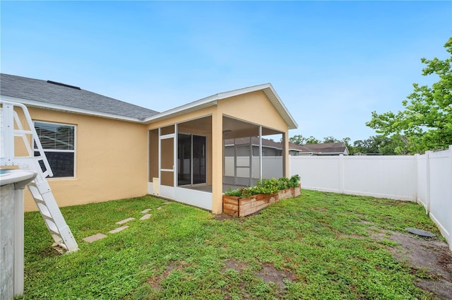6819 Glenbrook Dr, Lakeland, FL 33811 - back of property featuring a sunroom, stucco siding, and a shingled roof